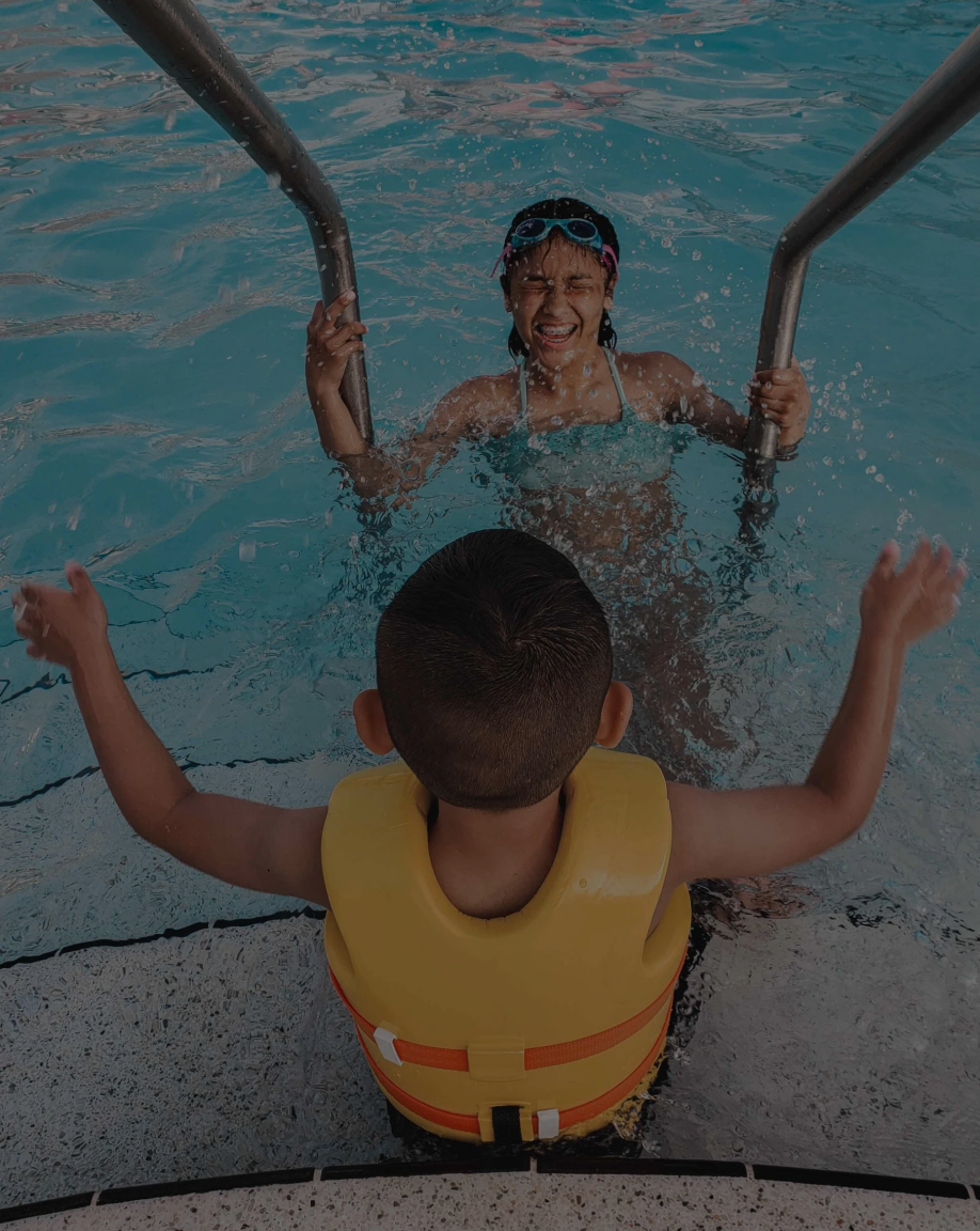 Child at the pool stairs